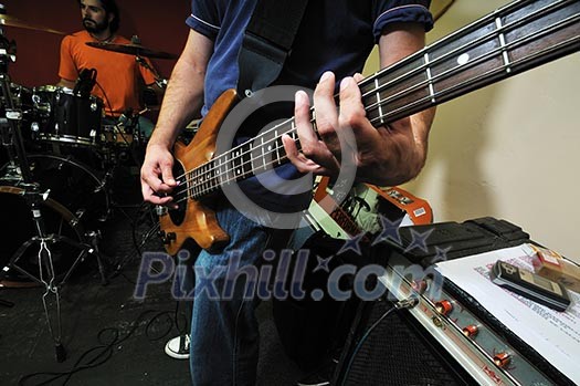 young music player and band friends have training in home garage