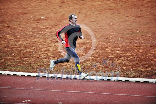 adult man running on athletics track and representing healthy and recreation concept
