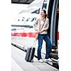 Pretty young woman boarding a train