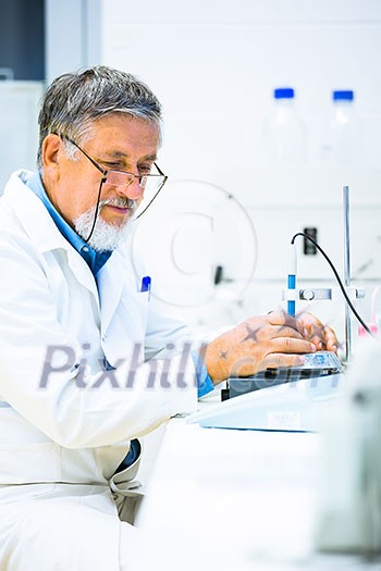Senior male researcher carrying out scientific research in a lab (shallow DOF; color toned image) Senior male researcher carrying out scientific research in a lab (shallow DOF; color toned image)