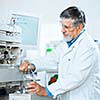 Senior male researcher carrying out scientific research in a lab (shallow DOF; color toned image)