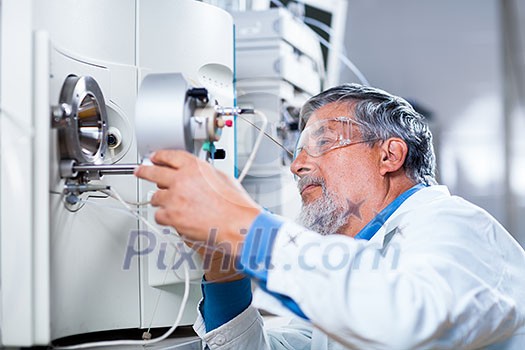 Senior male researcher carrying out scientific research in a lab (shallow DOF; color toned image)