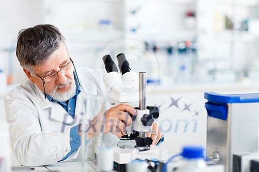 senior male researcher carrying out scientific research in a lab using a microscope (shallow DOF; color toned image)