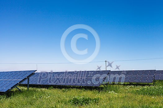 Sunlight as a resource of renewable energy: solar panels on a sunny day Sunlight as a resource of renewable energy: solar panels on a sunny day
