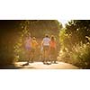 Young woman running outdoors on a lovely sunny summer evening (shallow DOF; color toned image)