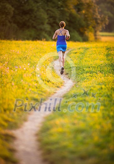 Young woman running outdoors on a lovely sunny summer evening (shallow DOF; color toned image) Young woman running outdoors on a lovely sunny summer evening (shallow DOF; color toned image)