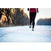 Winter running - Young woman running outdoors on a cold winter day