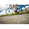 Motion blurred biker on a mountain road