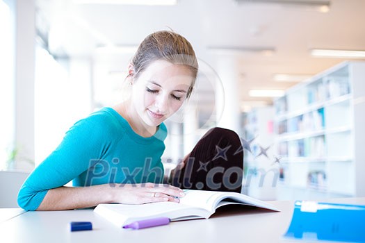 female college student in a library (shallow DOF; color toned image)