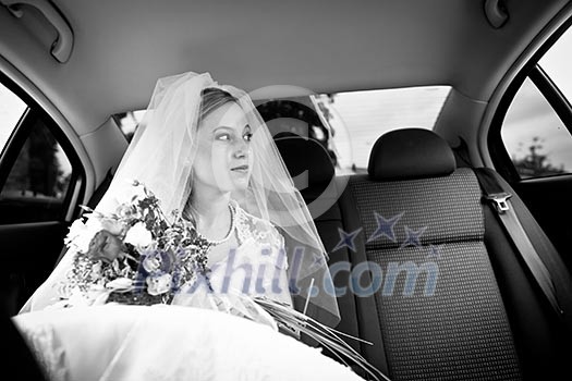 Portrait of a beautiful young bride waiting in the car on her way to the wedding ceremony Portrait of a beautiful young bride waiting in the car on her way to the wedding ceremony