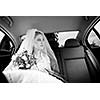 Portrait of a beautiful young bride waiting in the car on her way to the wedding ceremony