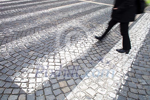 urban traffic concept - city street with a motion blurred crowd crossing a road