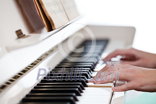 Playing Piano (shallow DOF; color toned image) Playing Piano (shallow DOF; color toned image)