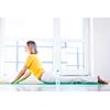 Pretty young woman doing YOGA exercise at home