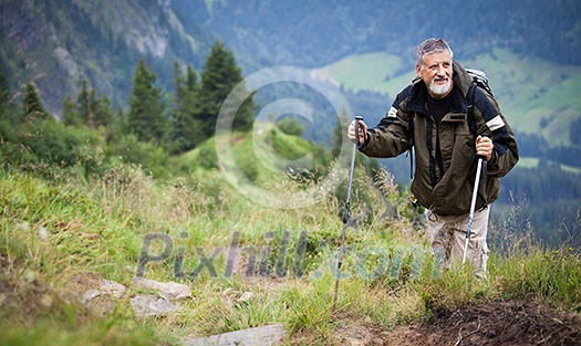 Active senior hiking in high mountains (Swiss Alps)