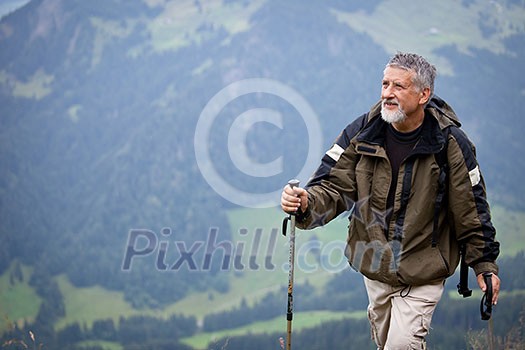 Active senior hiking in high mountains (Swiss Alps)
