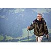 Active senior hiking in high mountains (Swiss Alps)