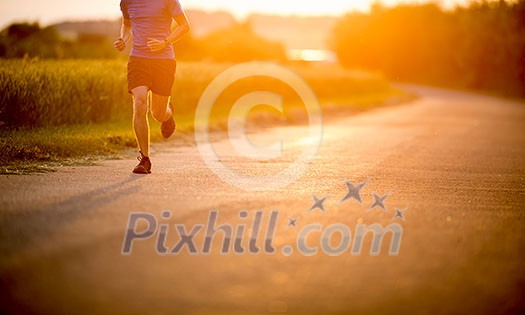 Male athlete/runner running on road - jog workout well-being concept