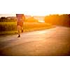 Male athlete/runner running on road - jog workout well-being concept