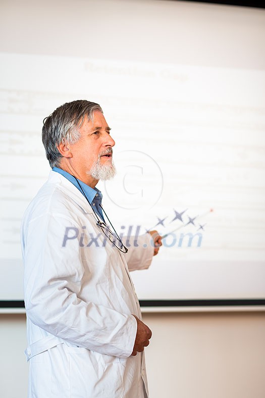 Senior chemistry professor giving a lecture in front of classroom full of students (shallow DOF; color toned image) Senior chemistry professor giving a lecture in front of classroom full of students (shallow DOF; color toned image)