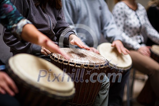 Group of people playing on drums - therapy by music Group of people playing on drums - therapy by music