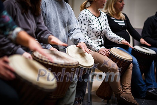 Group of people playing on drums - therapy by music