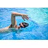 Young man swimming the front crawl/freestyle in a pool