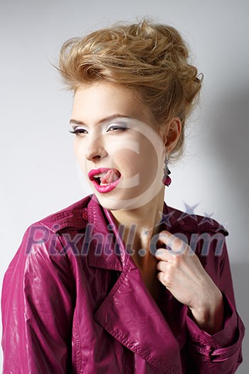 girl in a pink raincoat with makeup