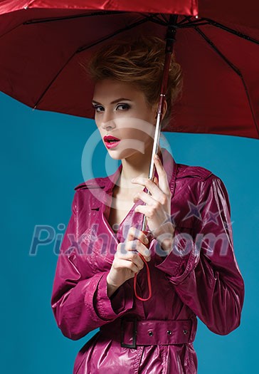 Young woman with umbrella on blue Young woman with umbrella on blue