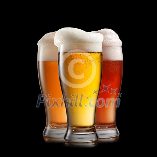 Different beer in glasses isolated on black background