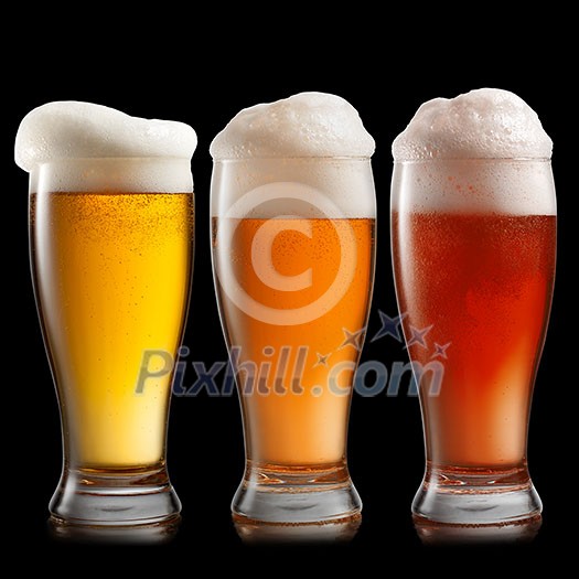 Different beer in glasses isolated on black background