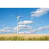 Wind generator turbine on summer landscape