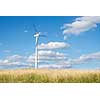 Wind generator turbine on summer landscape