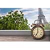 View of Paris and Eiffel tower from window with alarm clock