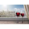 View of Paris and Eiffel tower from window with two glasses of wine