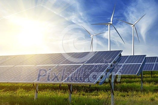 solar panels and wind generators under blue sky on sunset