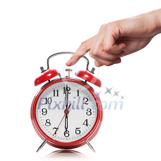 hand and red old style alarm clock isolated on white hand and red old style alarm clock isolated on white