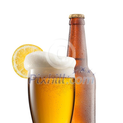 Beer in glass with lemon and bottle isolated on white Beer in glass with lemon and bottle isolated on white