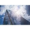 Modern building with reflection of blue sky and clouds