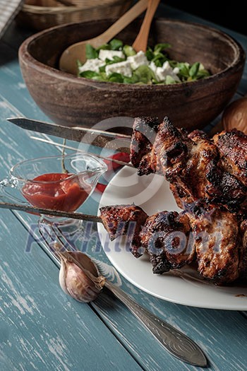 Shashlik with salad on the wooden table Shashlik with salad on the wooden table