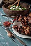 Shashlik with salad on the wooden table