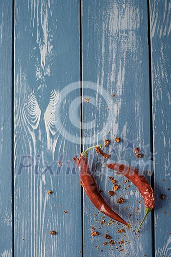 Red Hot Chili Peppers over blue wooden background Red Hot Chili Peppers over blue wooden background