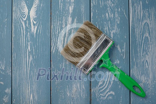 Paint brush on a blue wooden table