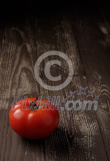 Tomato on a wooden table Tomato on a wooden table