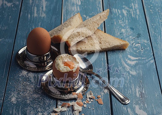 Boiled egg for breakfast on wooden table. Toned like instagram. Boiled egg for breakfast on wooden table. Toned like instagram.
