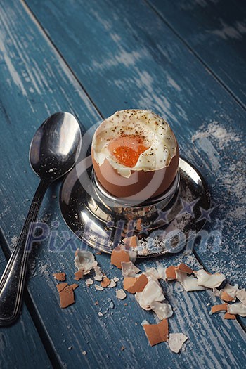 Boiled egg for breakfast on wooden table. Toned like instagram.
