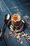 Boiled egg for breakfast on wooden table. Toned like instagram.