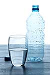 Empty bottles and glass of water on a wooden table