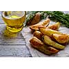 Oven-baked potatoes on a wooden table in rustic style