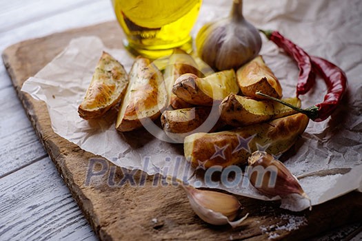Oven-baked potatoes on a wooden table in rustic style